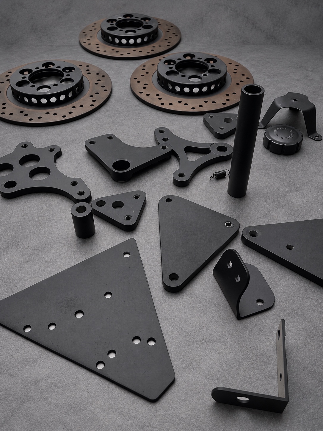 Black Cerakote E Series plates, spacers, brackets and brake disc centres with uncoated friction surfaces