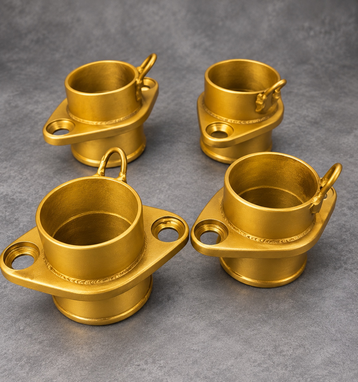 Four gold Cerakote V Series exhaust collets with flanges and spring loops