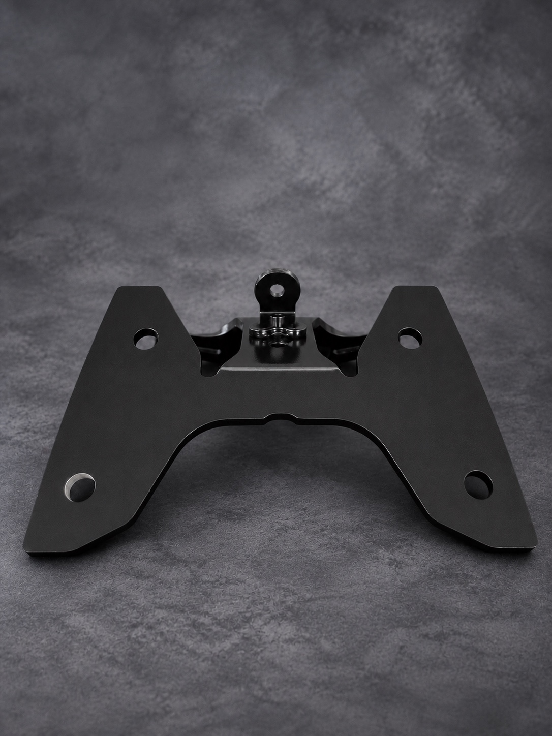 Front view of a black Cerakote E Series mounting bracket showing its contours and fixing holes