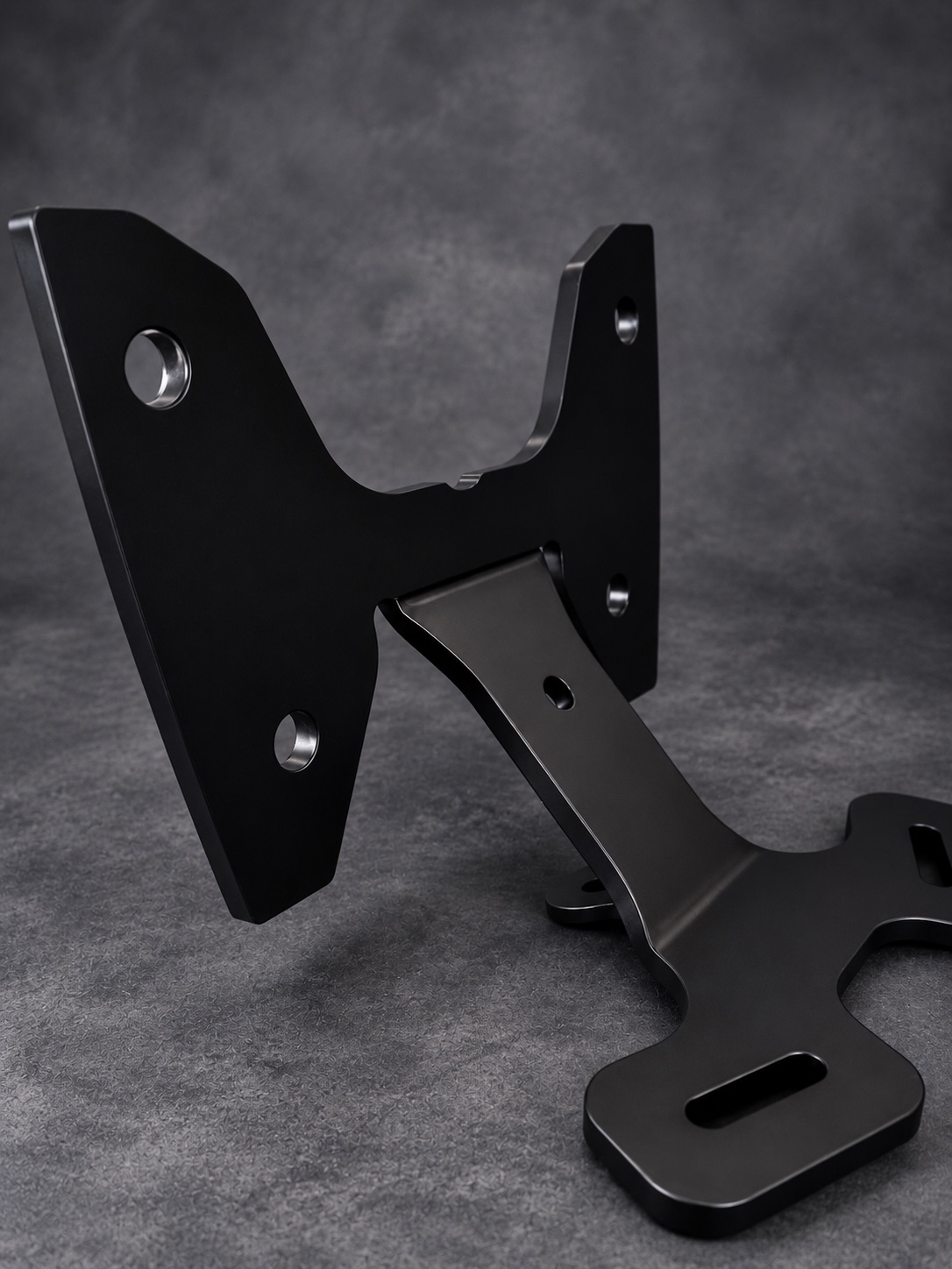 Reverse angle of a black Cerakote E Series mounting bracket with machined fixing holes
