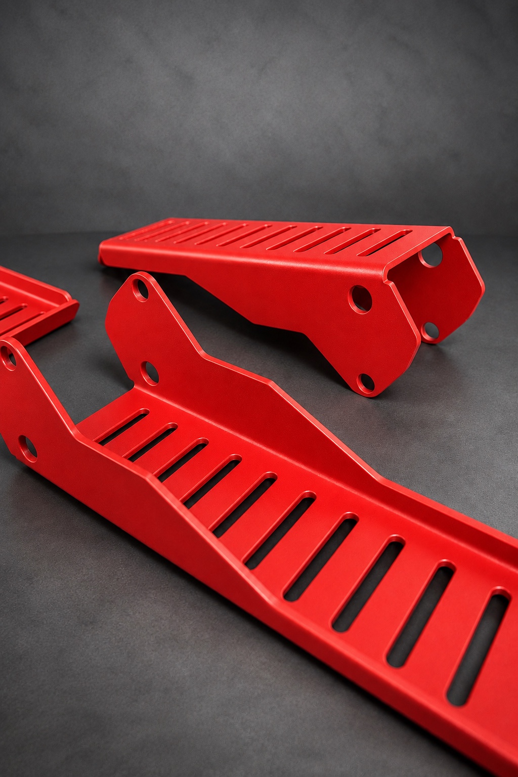 Red Cerakote E Series slotted brackets with folded edges and mounting holes
