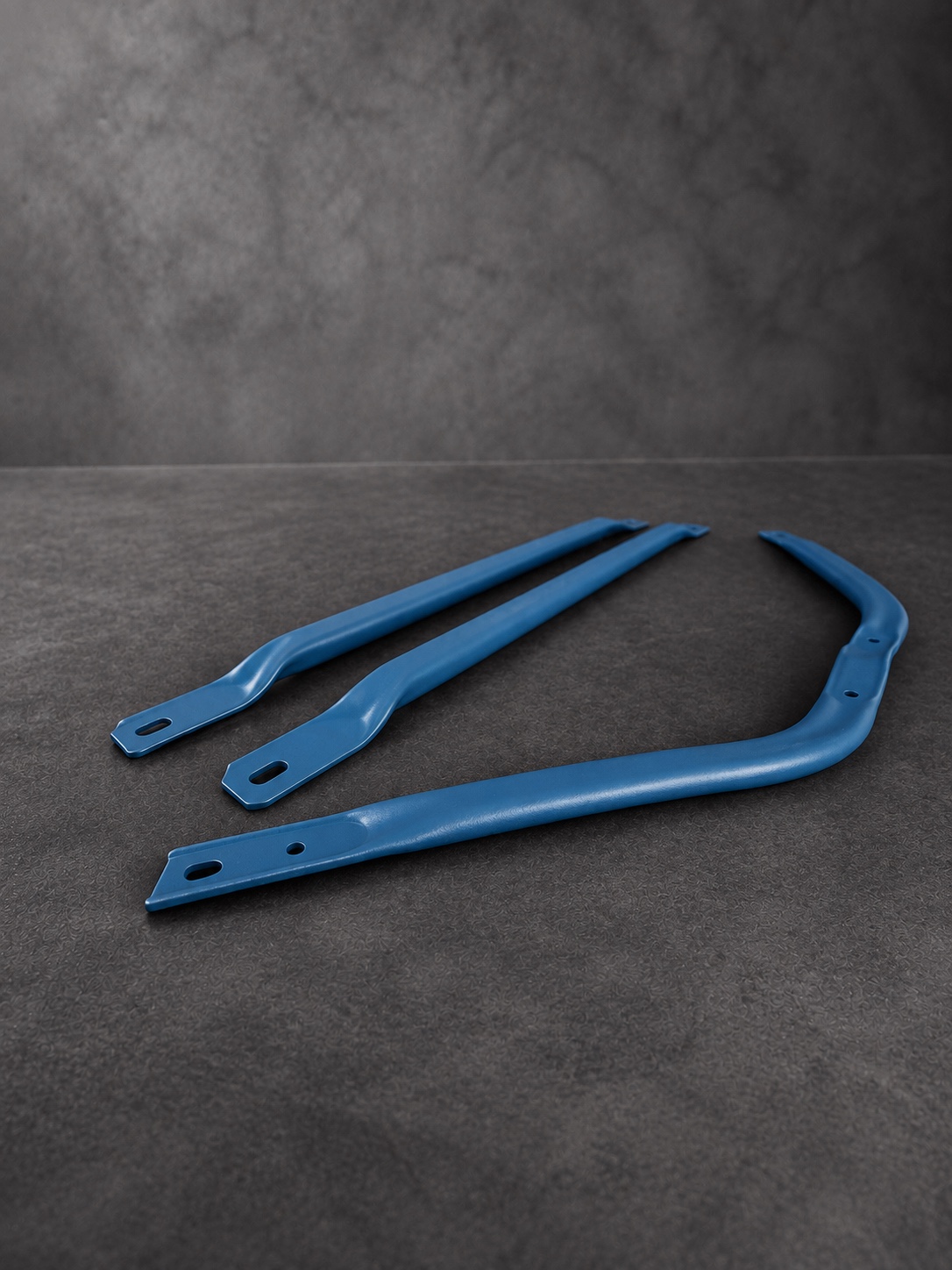 Alternate view of three blue Cerakote H Series brackets with their original shadows