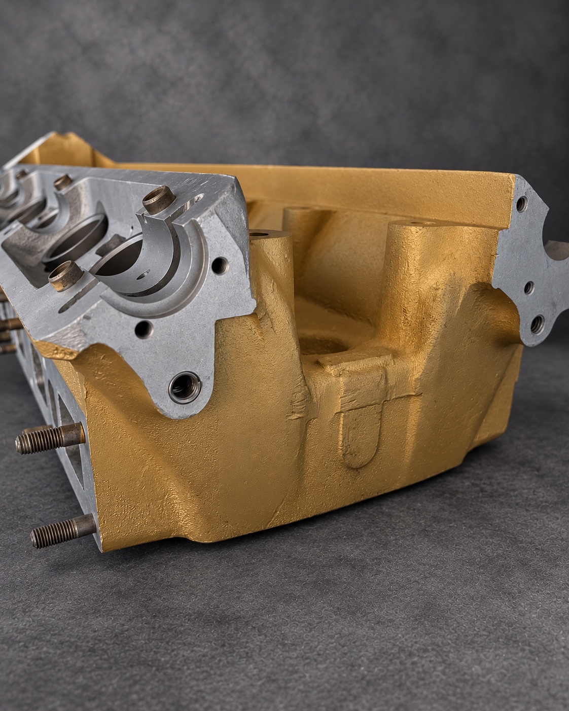 Gold Cerakote H Series cylinder head end detail showing casting texture and exposed machined surfaces