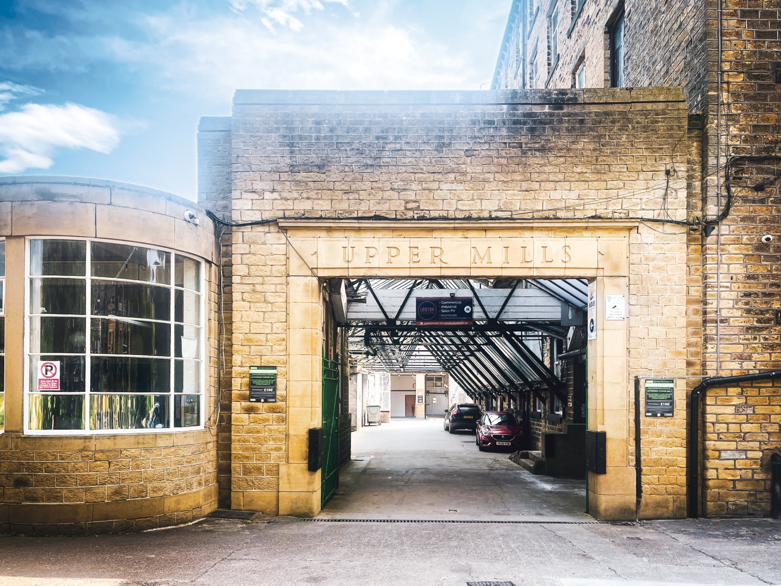 The stone archway marked Upper Mills at the entrance to the mill