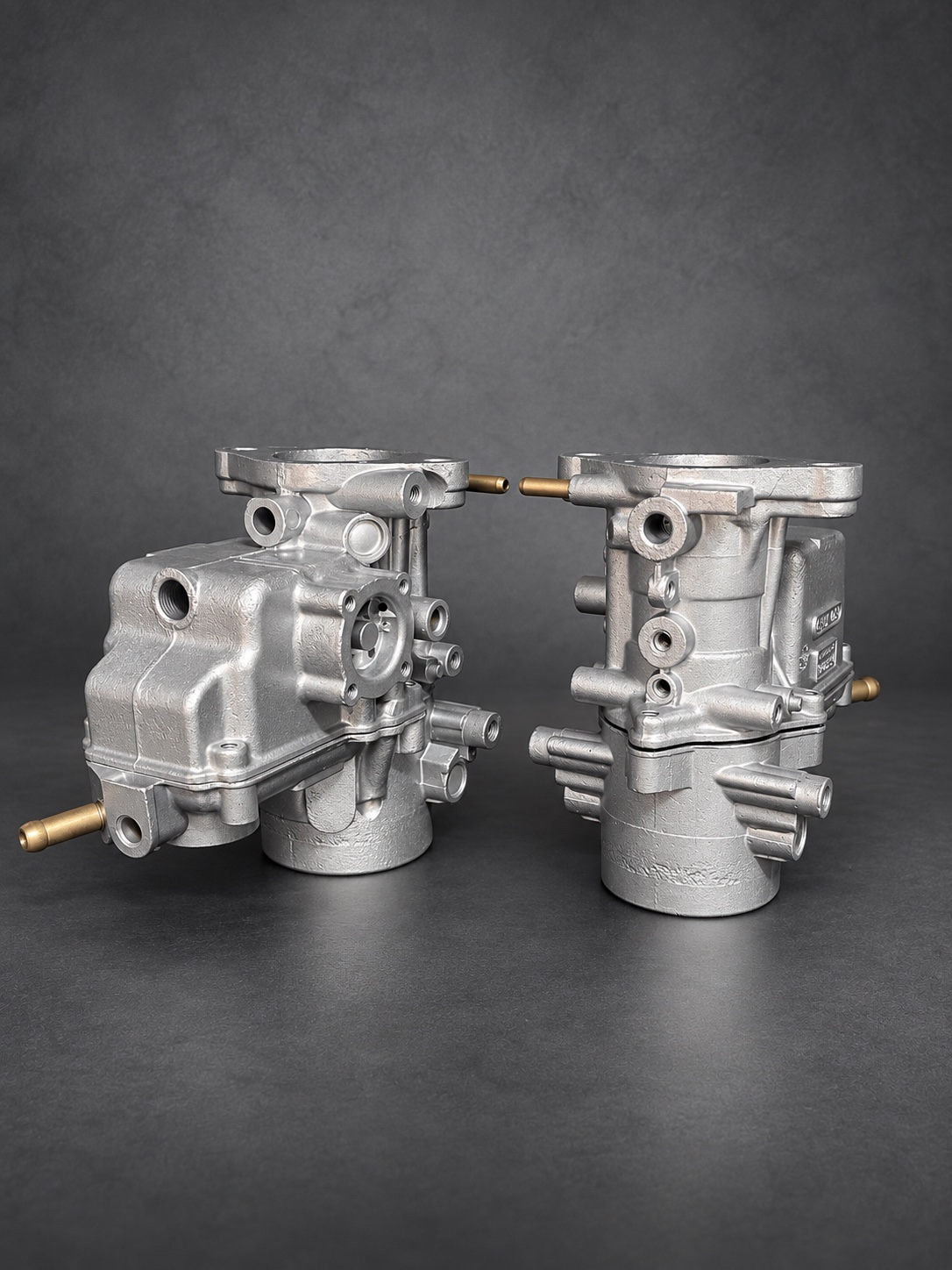 Pair of clean vapour-blasted carburettor bodies with brass pipes