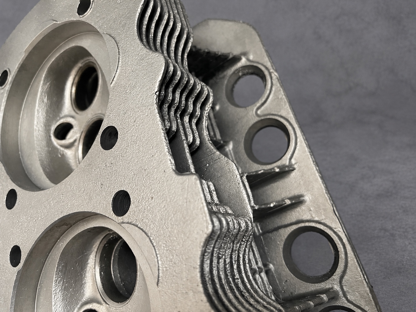 Vapour-blasted cylinder head showing cooling fins, ports and combustion chambers