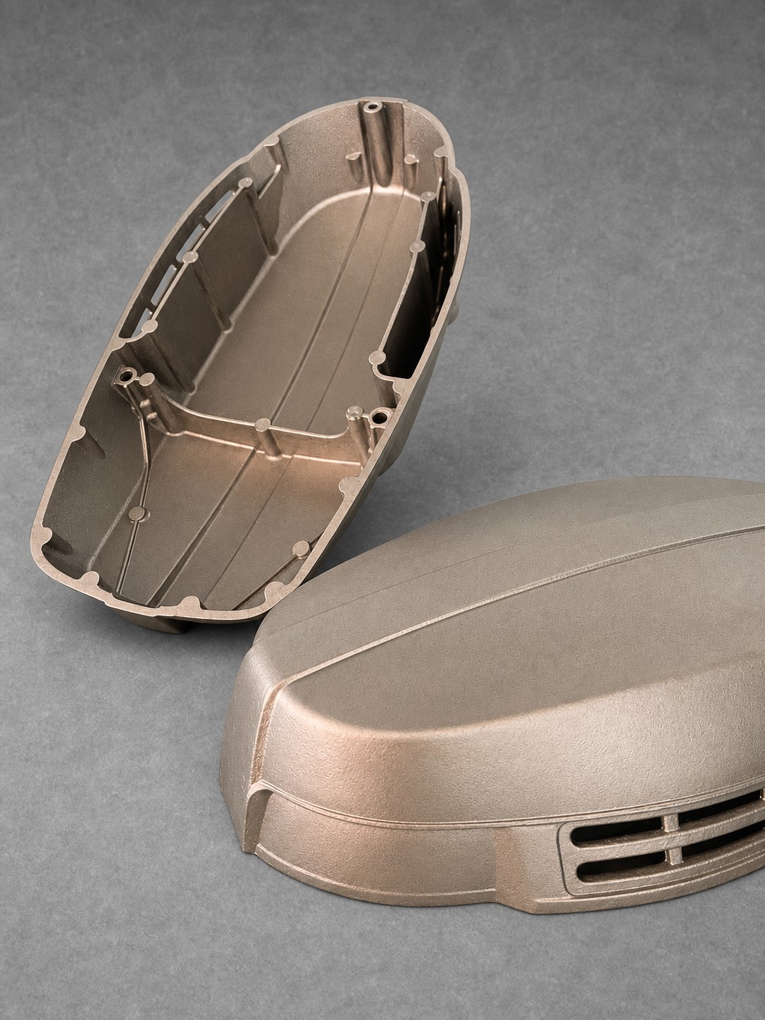 Vapour-blasted cast engine covers showing interior ribs and exterior contours