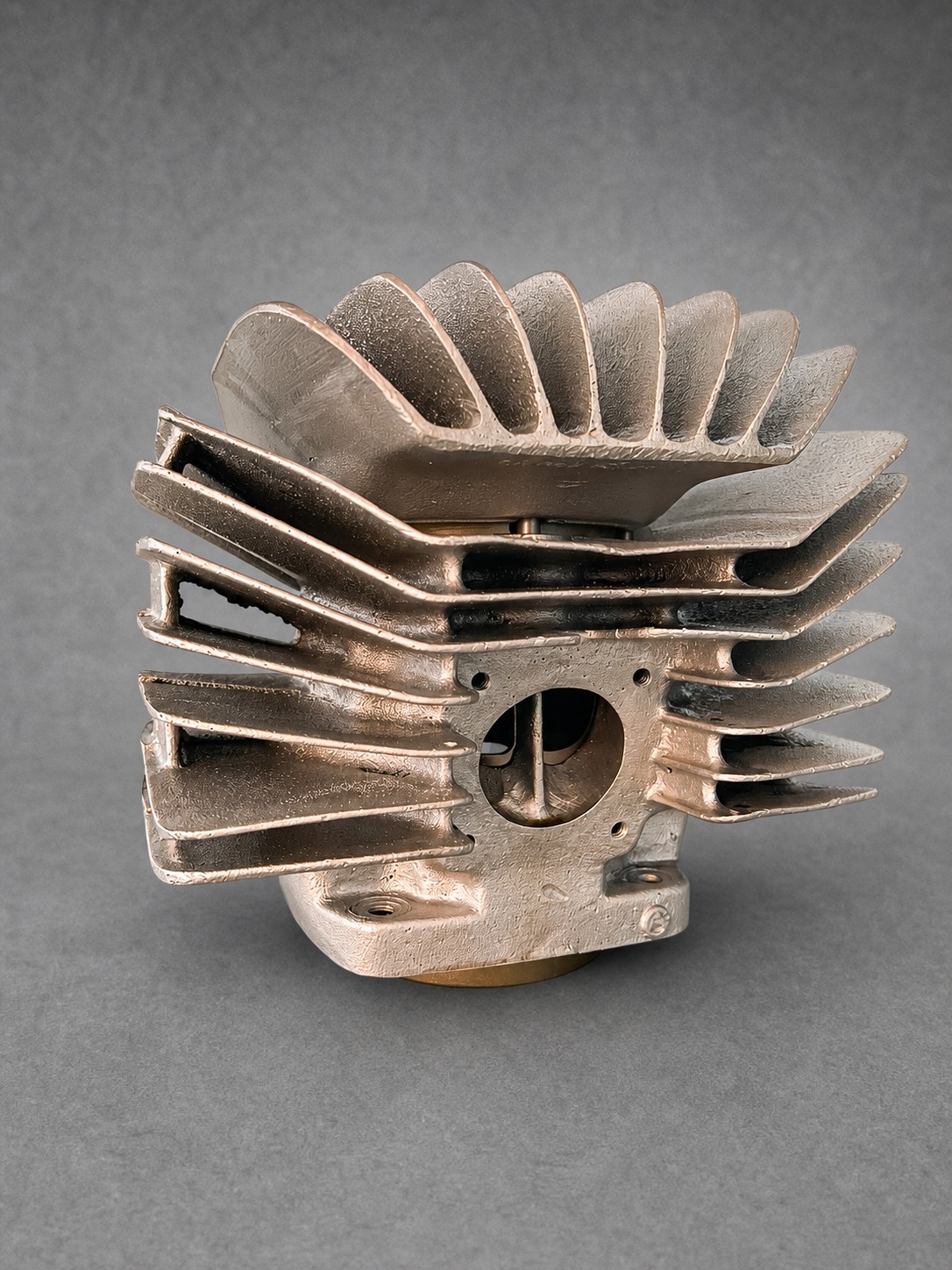 Vapour-blasted finned cylinder showing its port and casting texture